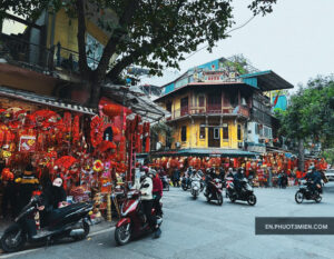 Phố Hàng Mã đông vui nhộn vào dịp lễ, với hàng quán trang trí đèn lồng rực rỡ và phương tiện qua lại tấp nập.